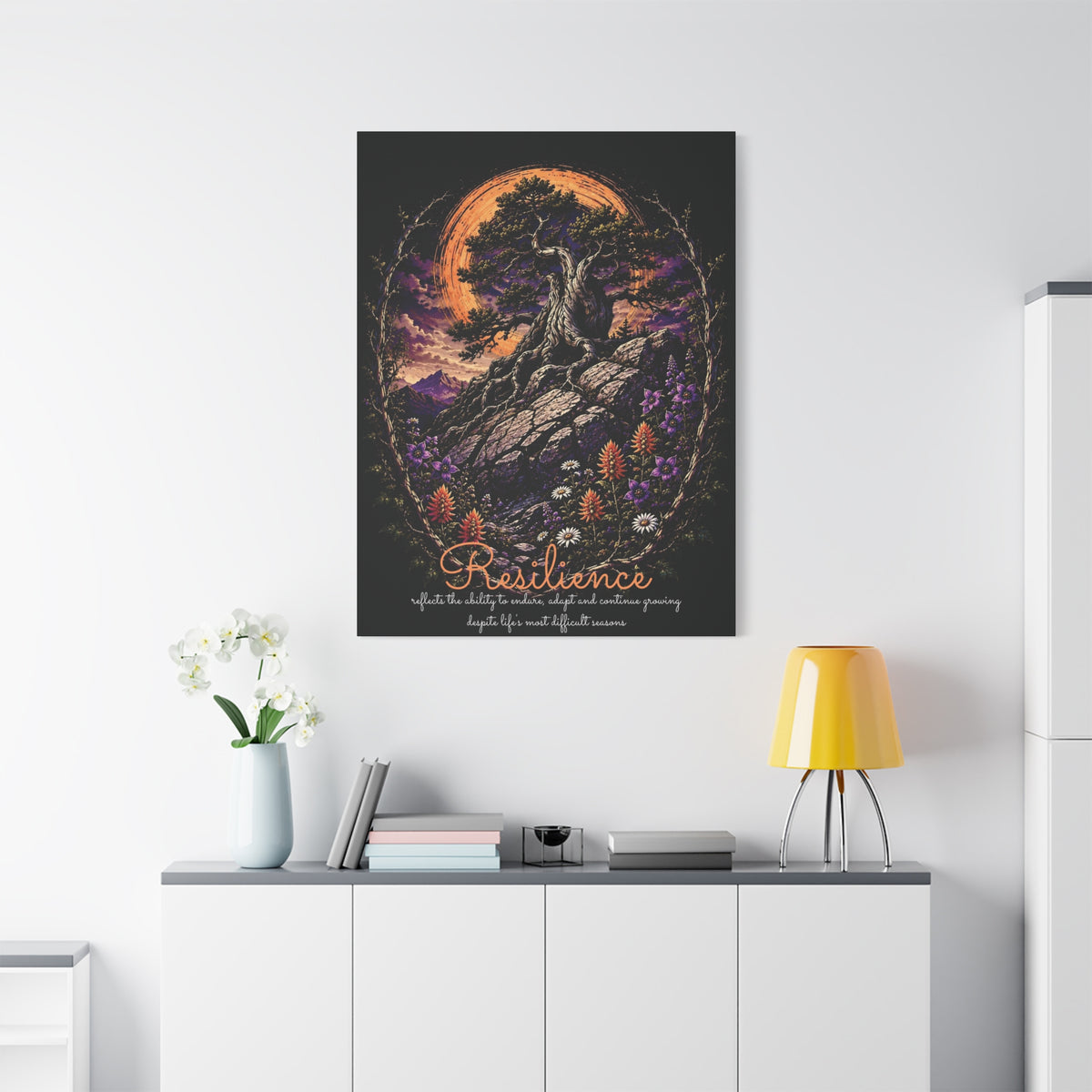 Resilience tree and wildflowers canvas displayed on a white wall above a console and lamp