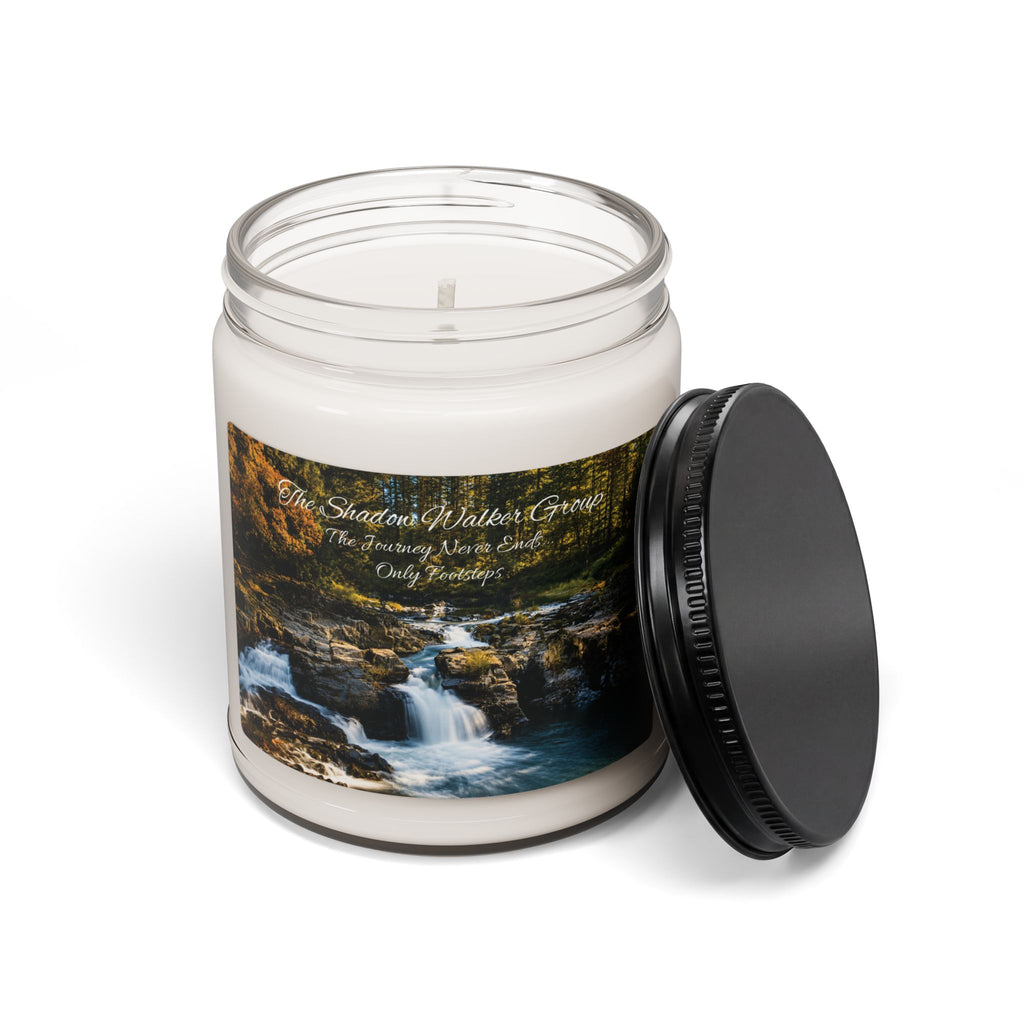 Open Be Still candle jar with river scene label and black lid beside it