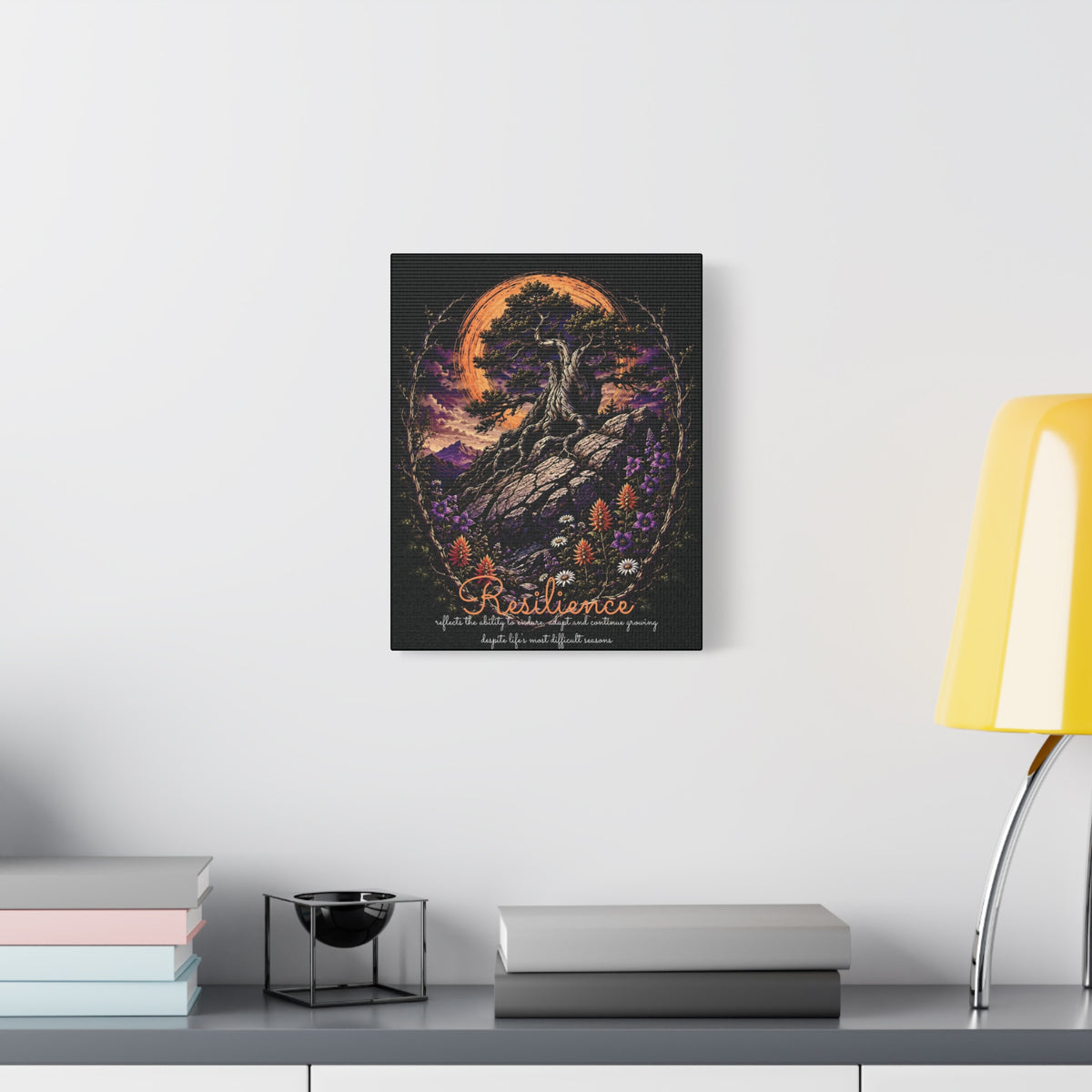 Resilience tree and wildflowers canvas displayed on a white wall above a console and lamp