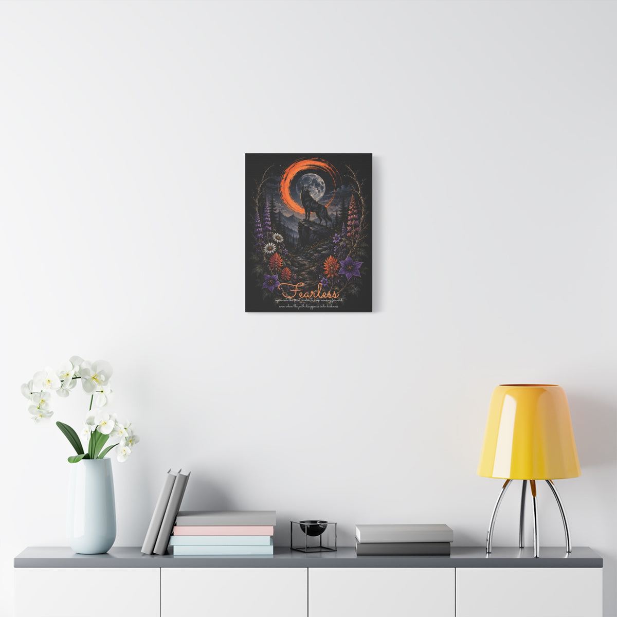 Fearless wolf and wildflowers canvas displayed on a white wall above a console and lamp