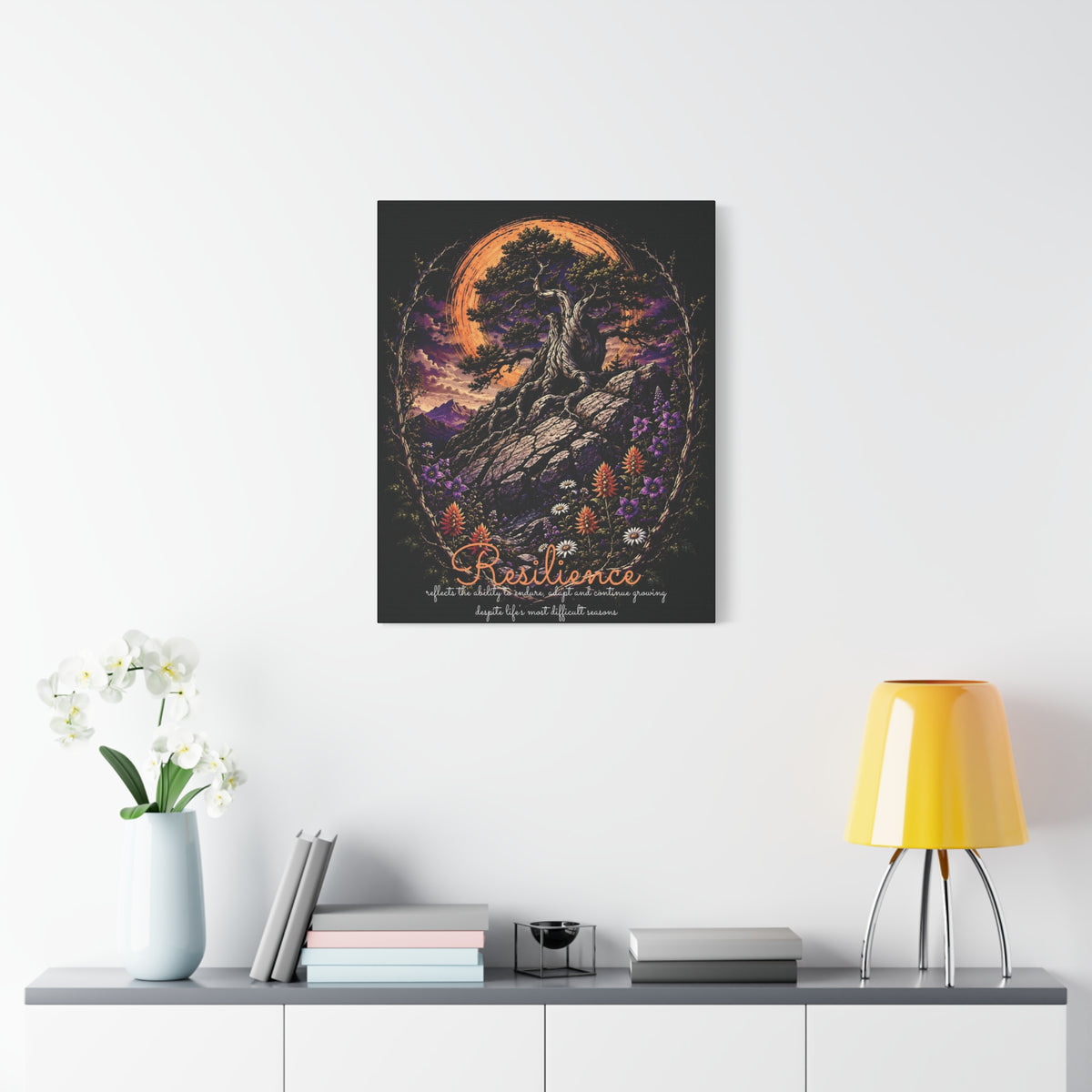 Resilience tree and wildflowers canvas displayed on a white wall above a console and lamp