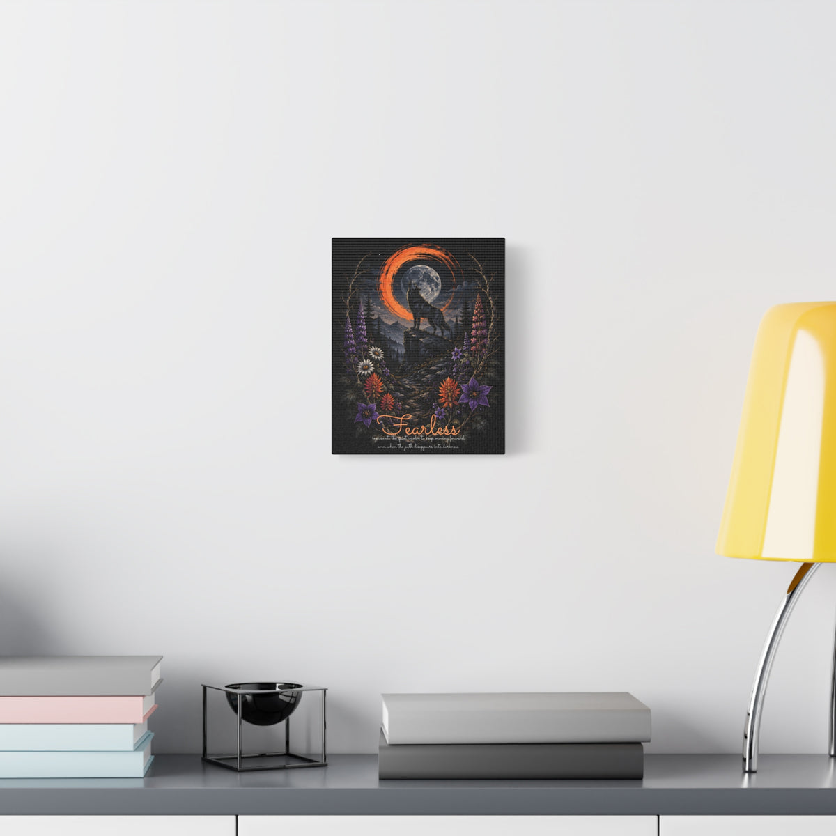 Fearless wolf and wildflowers canvas displayed on a white wall above a console and lamp
